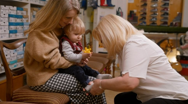 A child being fitted for their first pair of shoes